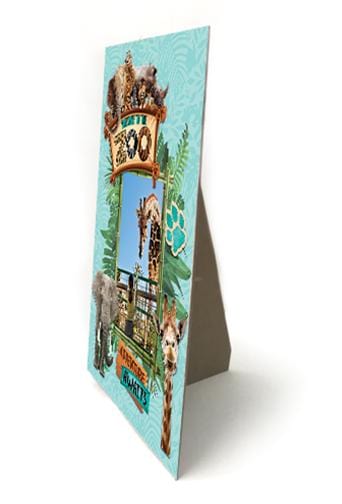 Easel back frame featuring a photo of a girl with a giraffe surrounded by zoo animal scrapbook stickers and greenery shown at an angle on a white background.