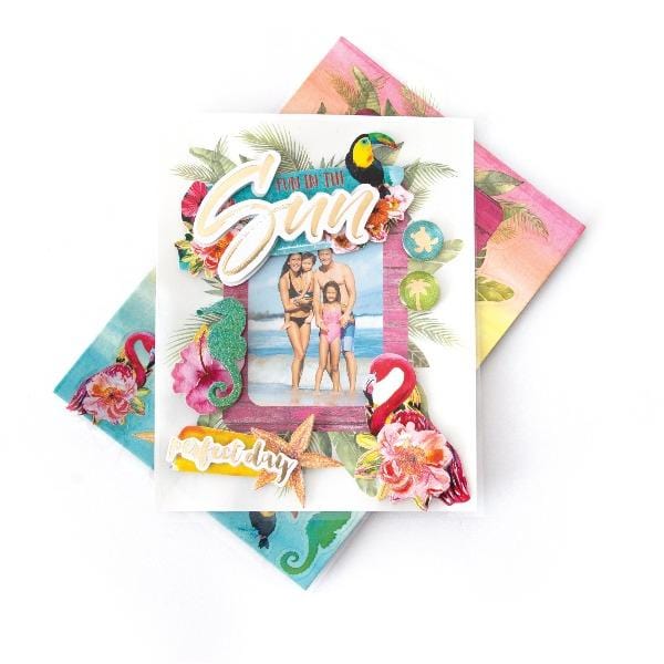3D scrapbook stickers frame featuring a photo of a family at the beach surrounded by colorful flamingos and florals shown above a sheet of colorful stickers on a white background.