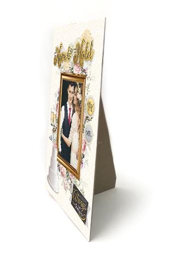 easel back frame featuring a photo of a wedding couple with gold accented stickers shown on an angle on a white background.
