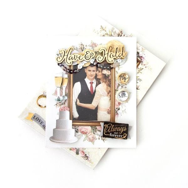 3D scrapbook stickers frame featuring a photo of a wedding couple surrounded by florals, champagne and gold accents shown above a sheet of stickers on a white background.