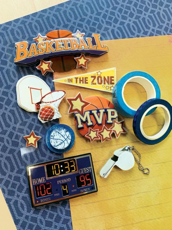 3D scrapbook stickers featuring basketball is shown next to 2 rolls of washi tape on top of blue and yellow patterned papers.