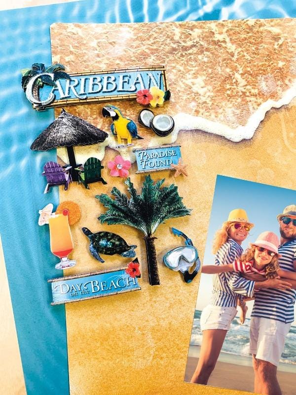 3D scrapbook sticker featuring the Caribbean theme is shown next to a photo of a family on the beach on top of 2 patterned scrapbook papers.