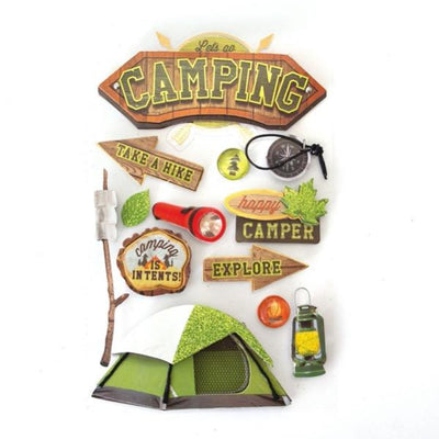 3D scrapbook stickers featuring a tent, marshmallows and a compass with gold details and green glitter.