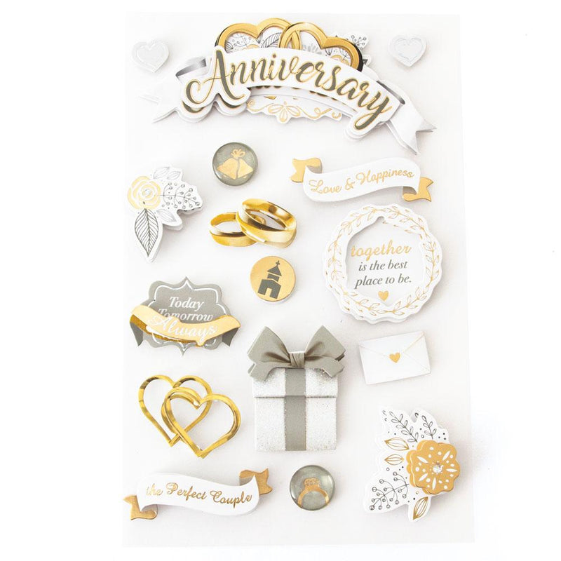 3D scrapbook stickers featuring white, gray and gold details including wedding rings and a box with a bow.
