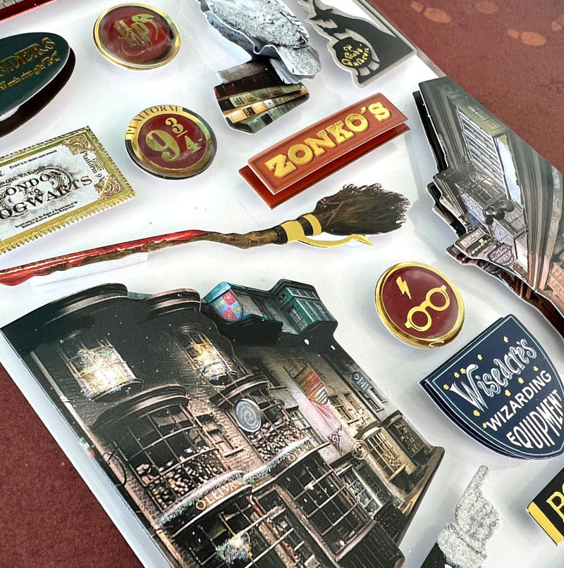 Close up of Harry Potter stickers featuring Diagon Alley, Hedwig, and street signs shown in package on dark red background.