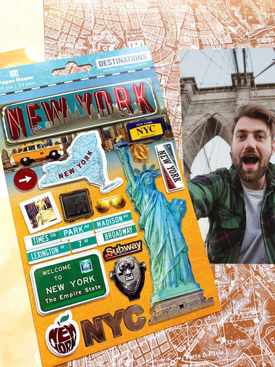 scrapbook stickers featuring New York, the Statue of Liberty, and street signs shown next to a photo of a young man on the Brooklyn Bridge.