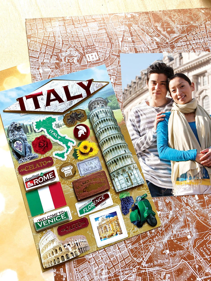 3D scrapbook sticker featuring Italy and the leaning tower of pisa shown next to a photo of a young couple on a background of patterned papers.