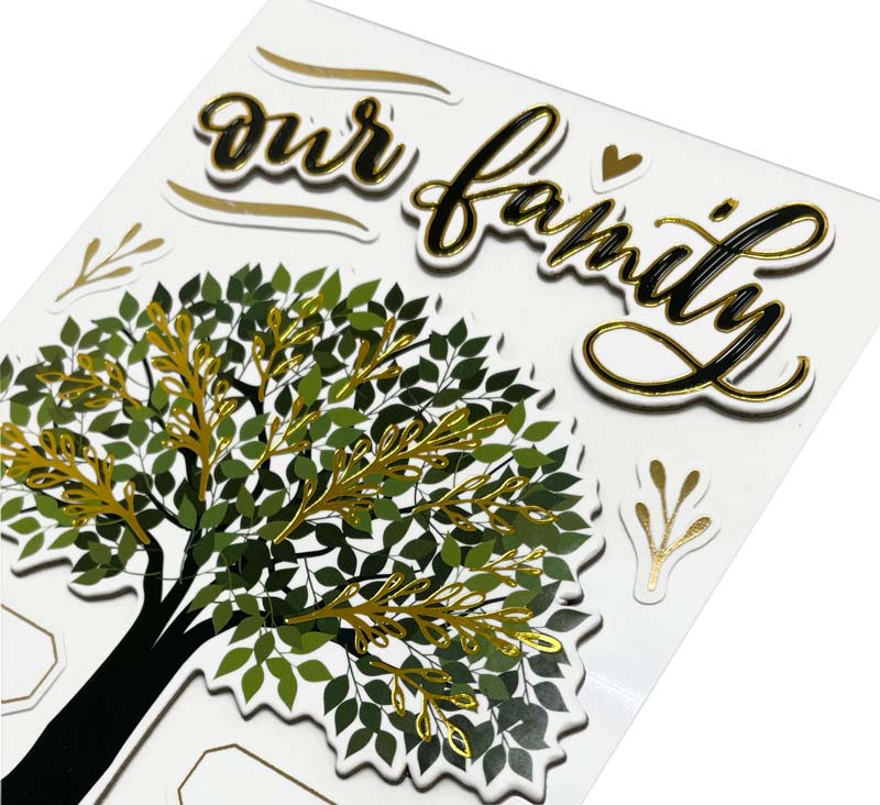 close up of scrapbook stickers featuring a family tree and title with gold details.