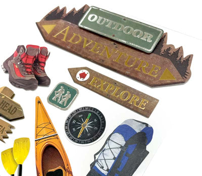 close up of scrapbook stickers featuring photo real hiking boots, kayak, backpack and gold detailed, wooden signs.