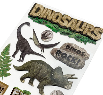 close up of scrapbook stickers featuring illustrated dinosaurs.