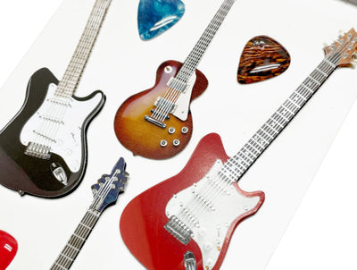 Close up of scrapbook stickers featuring colorful electric guitars.