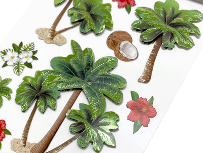 Close up of 3D scrapbook stickers featuring palm trees and tropical flowers.ing