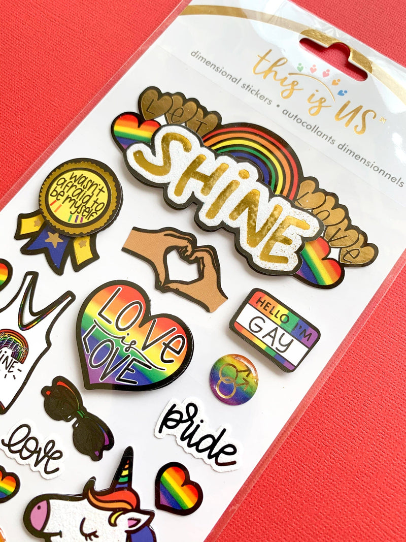 Pride sticker from craft kit featuring rainbows and unicorns, shown in package on red background.