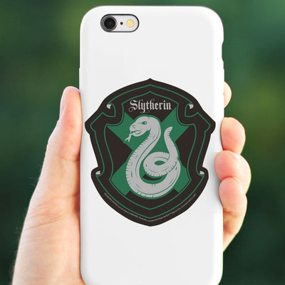 vinyl laptop sticker featuring Harry Potter Slytherin Shield shown adhered to the back of a white iphone held in a hand.
