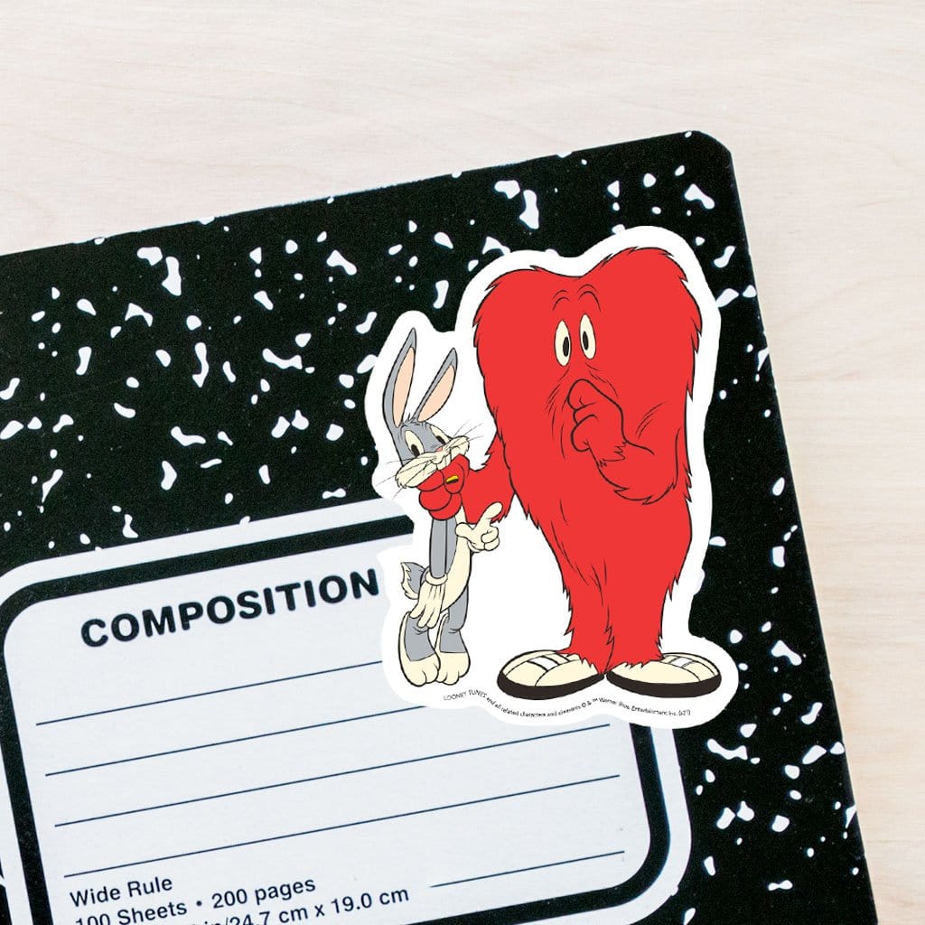 vinyl laptop sticker featuring a diecut Gossamer and Bugs adhered to the front of a black and white composition notebook.