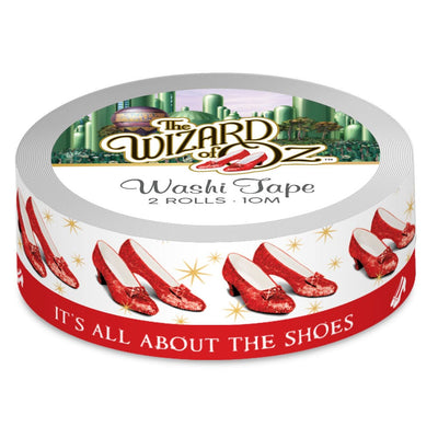The Wizard of Oz washi tape set featuring the Ruby Slippers on one roll stacked above a solid red roll with text, shown in package on white background.