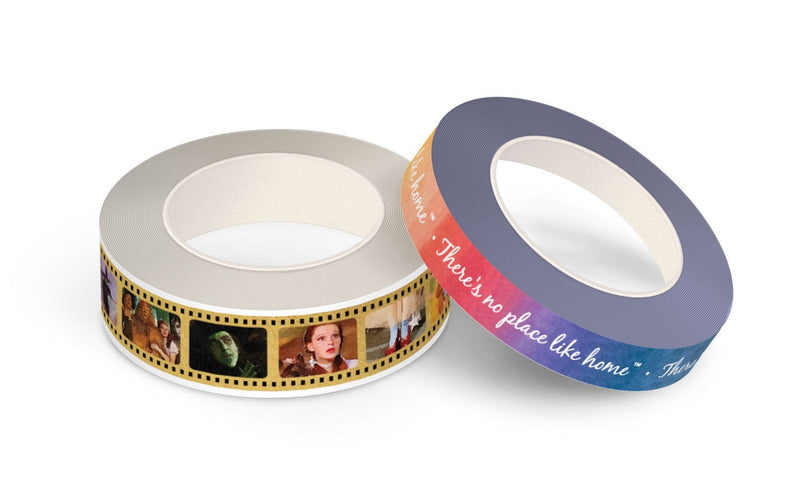 2 rolls of washi tape featuring scenes from the Wizard of Oz movie and text on rainbow colored background, shown on white background.