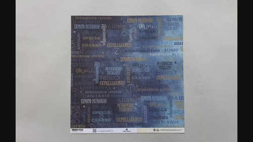 Female hands pick up harry potter scrapbook paper featuring text depicting spells like "Alohomora" and "Lumos" on one side with the swish & flick wand motions in beige on the reverse.
