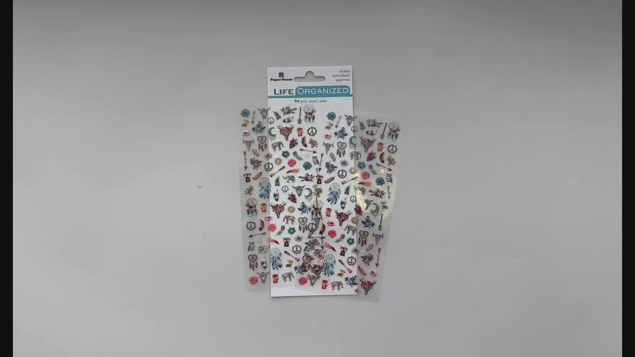 Female hands pick up and show front and back details of mini stickers featuring dream catchers, feathers and directional arrows.