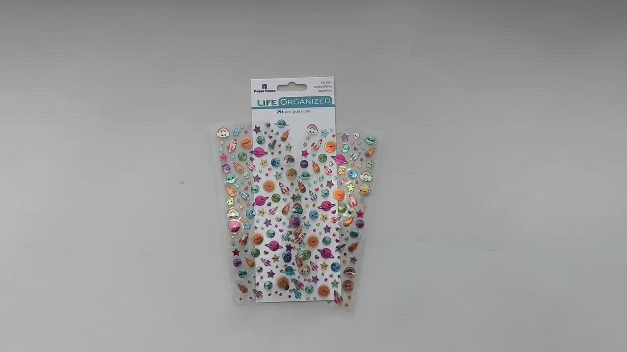 Female hands pick up and show front and back details of mini stickers featuring kawaii comets and stars.