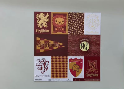 Female hands display Harry Potter scrapbook paper featuring Gryffindor tags on one side and a gryffindor pattern on the reverse.