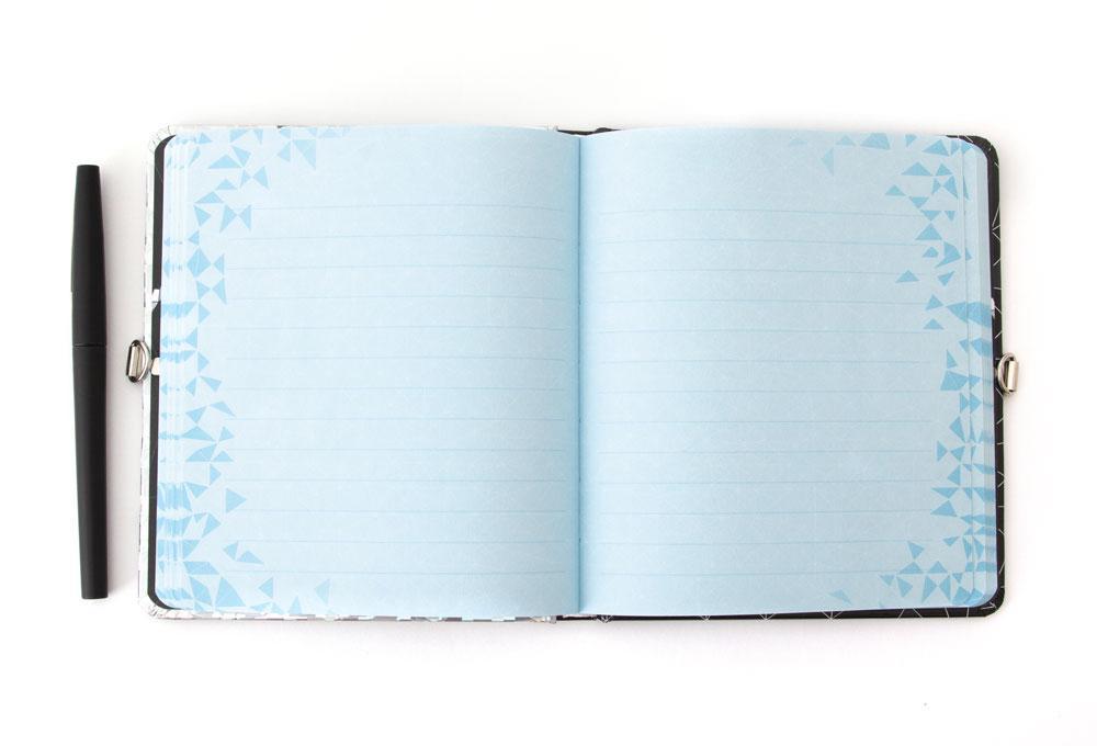 Justice League locking diary shown open featuring light blue lined pages and a black pen.