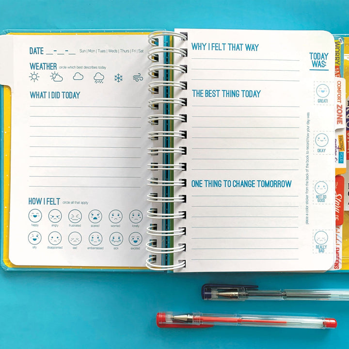 kids journal featuring an open spread with 2 gel pens, shown on teal background.