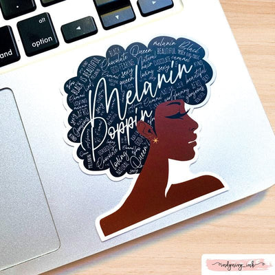 Shaped laptop sticker featuring an illustration of a brown-skinned woman, with Melanin Poppin' sentiments written on her hair, shown on a computer laptop.