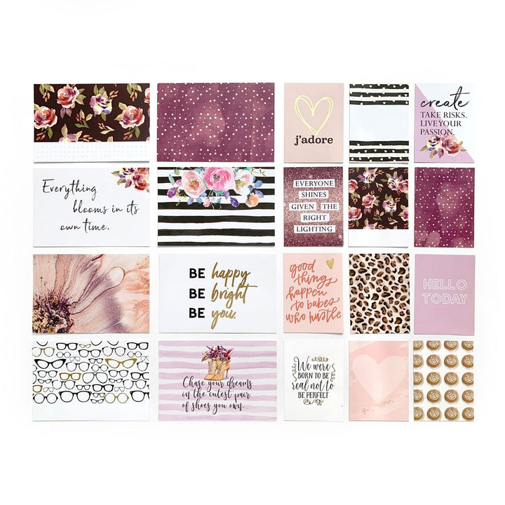 An assortment of paper tags feature inspirational words, florals, patterns and gold foil.