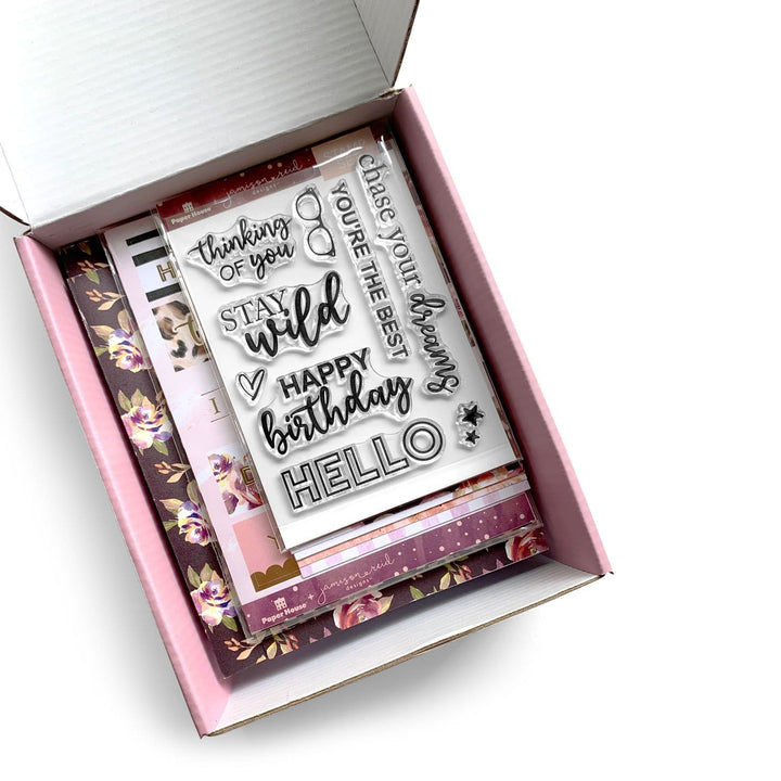 Craft kit package shown open with cards, stickers and stamps inside.