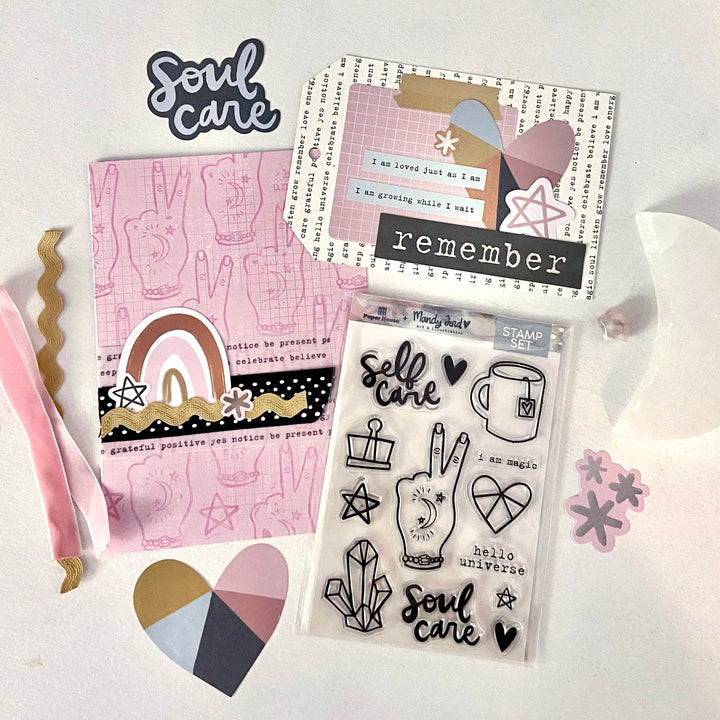 Pink card with peace sign hands on background and whimsical rainbow embellishment; gift card on white background with typewriter-styled text, heart embellishment and the word, remember, in white text on black background. Other elements from the Mandy Ford Soul Care craft kit in background.