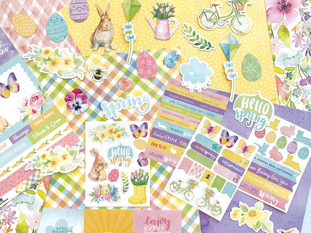 KIT-0121E - Paper Crafting Kit - Hello Spring - Colorful spring-themed paper crafting supplies including patterned cardstock, decorative stickers, and washi tape strips with flowers, bunnies, and seasonal messages