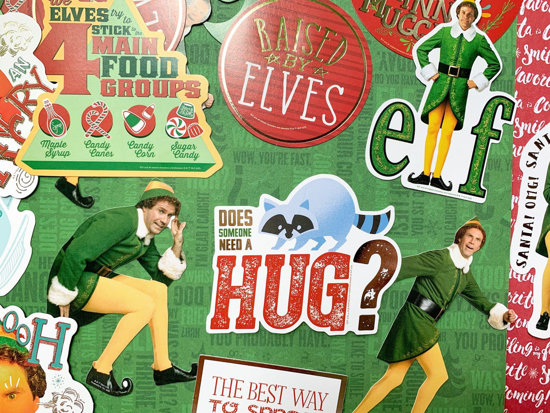Craft kit featuring close up of die cuts shown on green scrapbook paper, all of scenes and characters from the movie Elf.