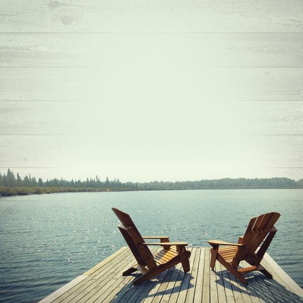 Photographic scrapook paper featuring a lake scene of two chairs on a dock with an expansive lake ahead.