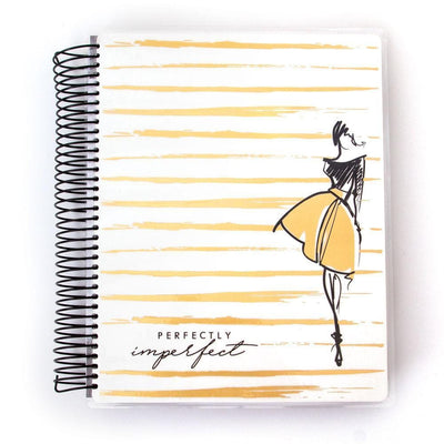 Perfectly Imperfect weekly planner image shows cover featuring an illustration of a woman with words on a gold striped background with a black coil spine.