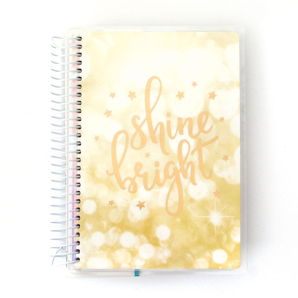 PL-4005E - Weekly Planner - Shine Bright 12 Month Undated Mini - Spiral-bound mini planner with gold "Shine Bright" script text and stars on a soft yellow gradient background