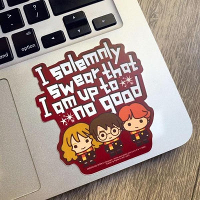 Shaped Harry Potter laptop sticker featuring 3 chibi characters and "I solemnly swear…" sentiment is shown on a silver laptop computer.