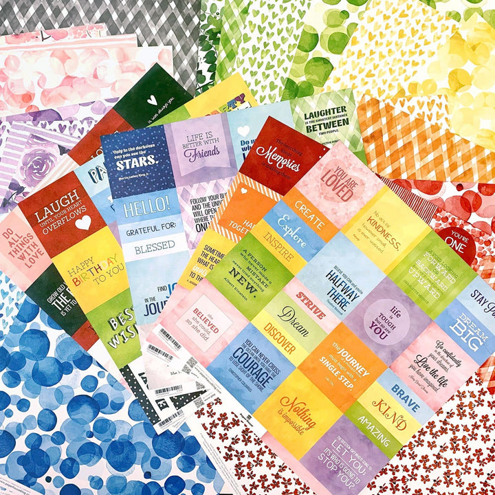 PSET-0001E - Scrapbook Paper - Colorways 30 Sheet Bundle - Colorful scrapbook paper sheets with inspirational text and patterned designs in rainbow colors displayed flat lay