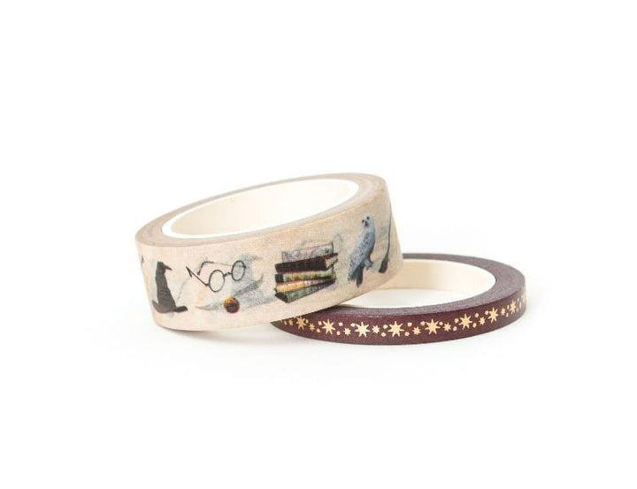 2 rolls of Harry Potter ™ washi tape featuring books, sunglasses, sorting hat and gold stars, shown on white background.
