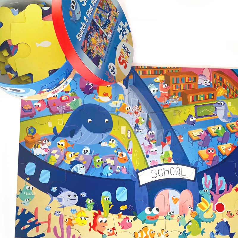 Assembled floor puzzle featuring finny the shark shown on white background with open package.