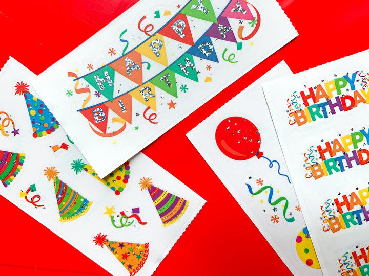 ST-2346E - Stickers - Happy Birthday Banners - Colorful birthday sticker sheets featuring party hats, balloons, bunting banners, and "Happy Birthday" text on white background