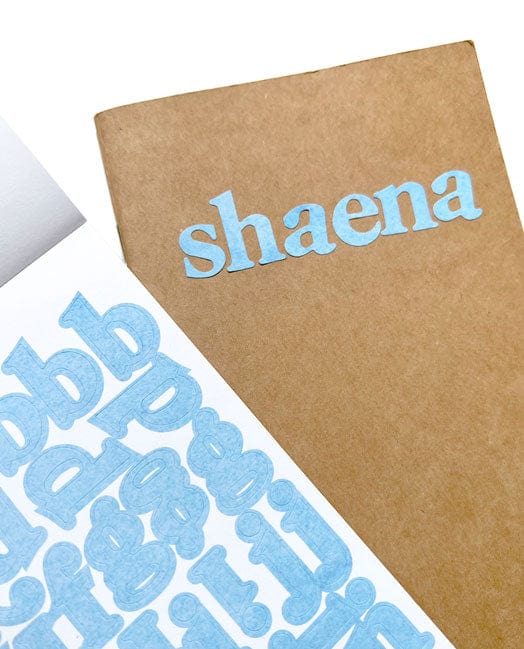 STBK-1001E - Alphabet Stickers - Alphabooks Colorways Serifs - Blue serif alphabet stickers displayed on kraft paper packaging labeled "shaena."