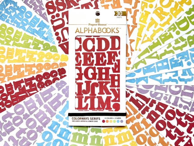 STBK-1001E - Alphabet Stickers - Alphabooks Colorways Serifs - Red serif alphabet sticker sheet displayed on colorful background of scattered letters in multiple colors