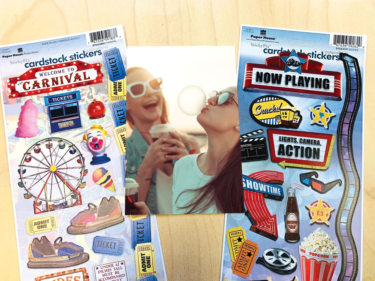 STCX-4043E - Scrapbook Stickers - Movie and Carnival Value Pack - Two cardstock sticker sheets featuring carnival and movie-themed designs including Ferris wheel, tickets, popcorn, and film reels on wood surface