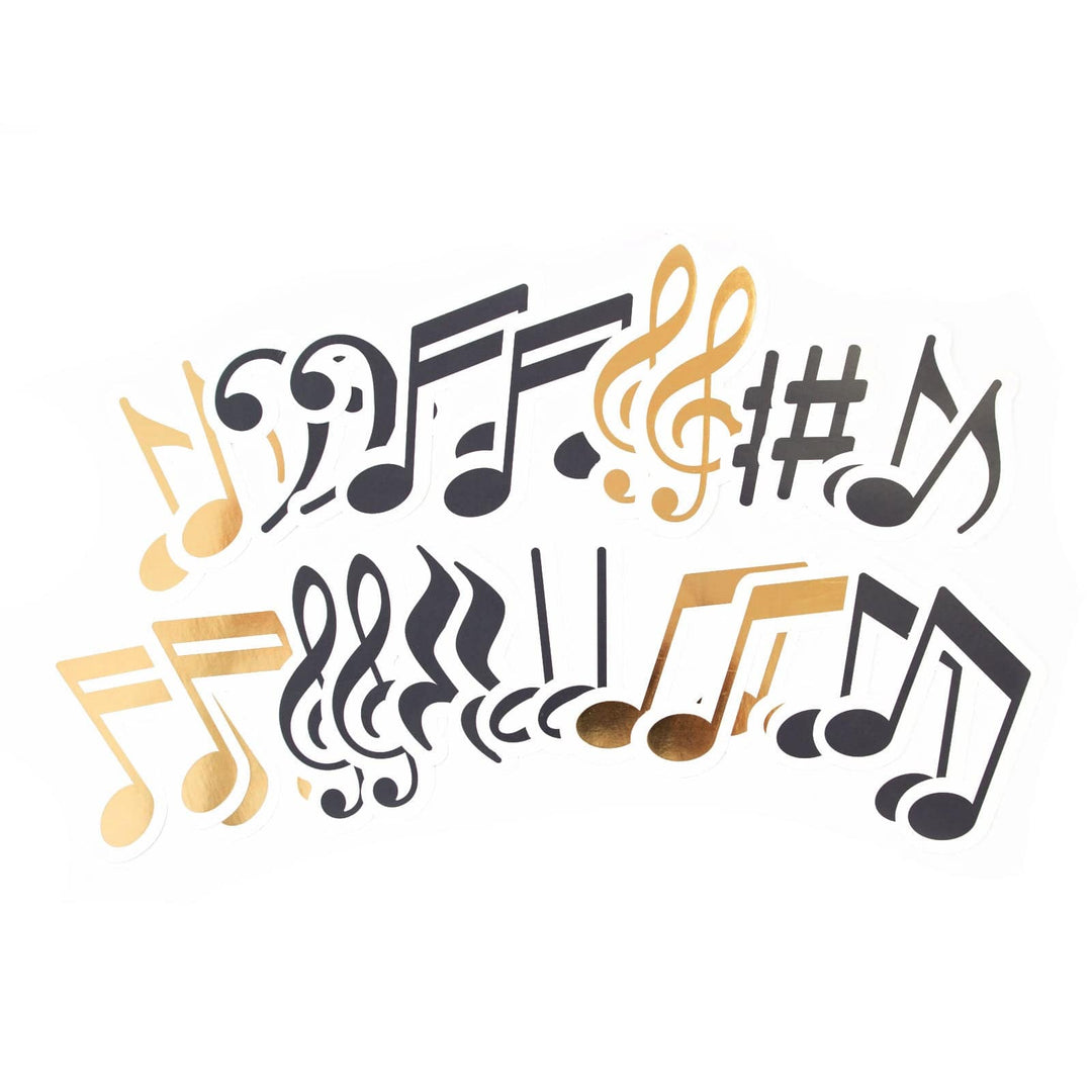 An assortment of scrapbook stickers shown fanned out, featuring black and gold music notes on a white background.