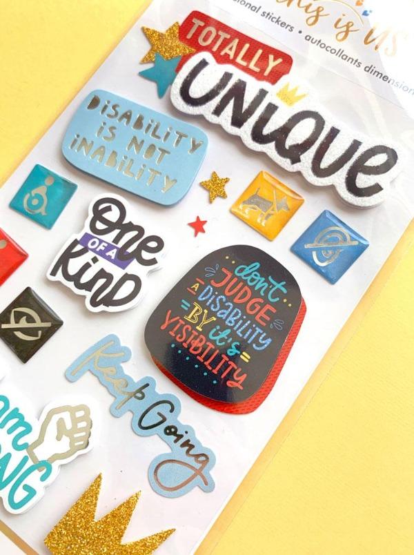 3D scrapbook stickers featuring colorful sentiments of uniqueness shown on a yellow background.